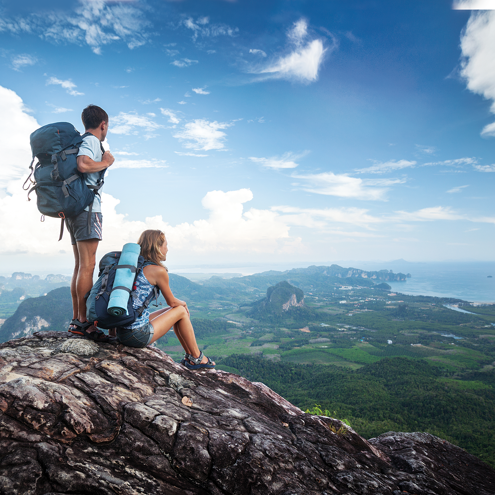 2 hikers enjoying view from mountaintop