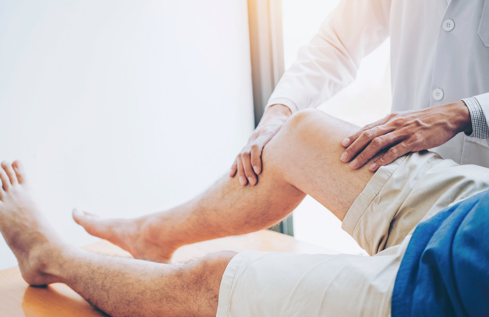 Healthcare professional examining patients right knee