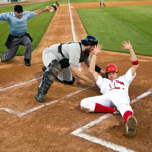 baseball player sliding into home base 