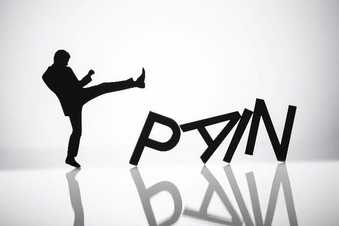 figure kicking the letters that spell pain over