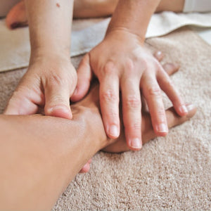 hands massaging an arm