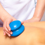 therapist using blue suction cup on someones back