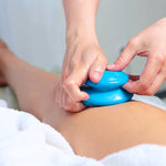 therapist using blue suction cup on someones knee