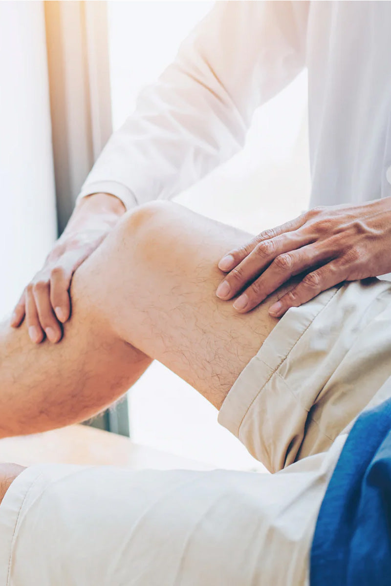 Doctor examining patients right knee