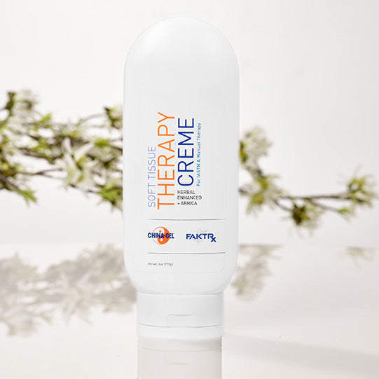 soft tissue therapy creme 6oz tottle with tree twigs in background