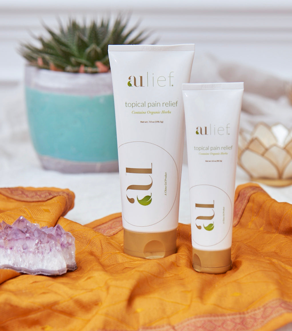 aulief 7 oz and 3.2 oz plastic tubes with plant in the background