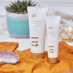 aulief 7 oz and 3.2 oz plastic tubes with plant in the background