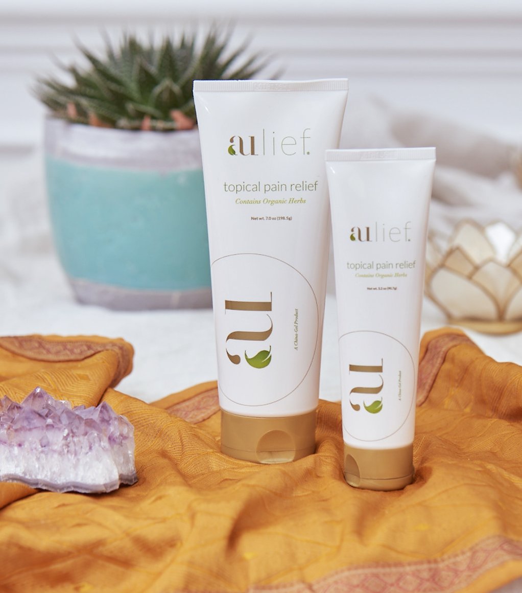 aulief 7 oz and 3.2 oz plastic tubes with plant in the background